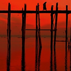 Monk crossing U-Bein bridge